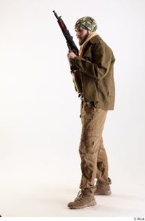Andrew Elliott Insurgent Holding Machine Gun holding gun standing whole…